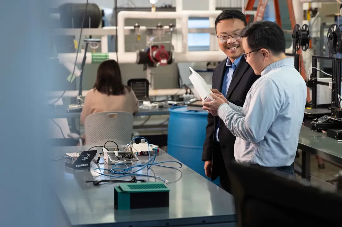 Bing Dong in lab classroom talking to another person.