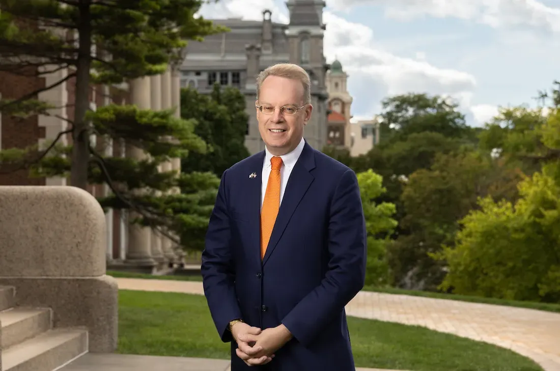 Chancellor Kent Syverud standing and smiling.