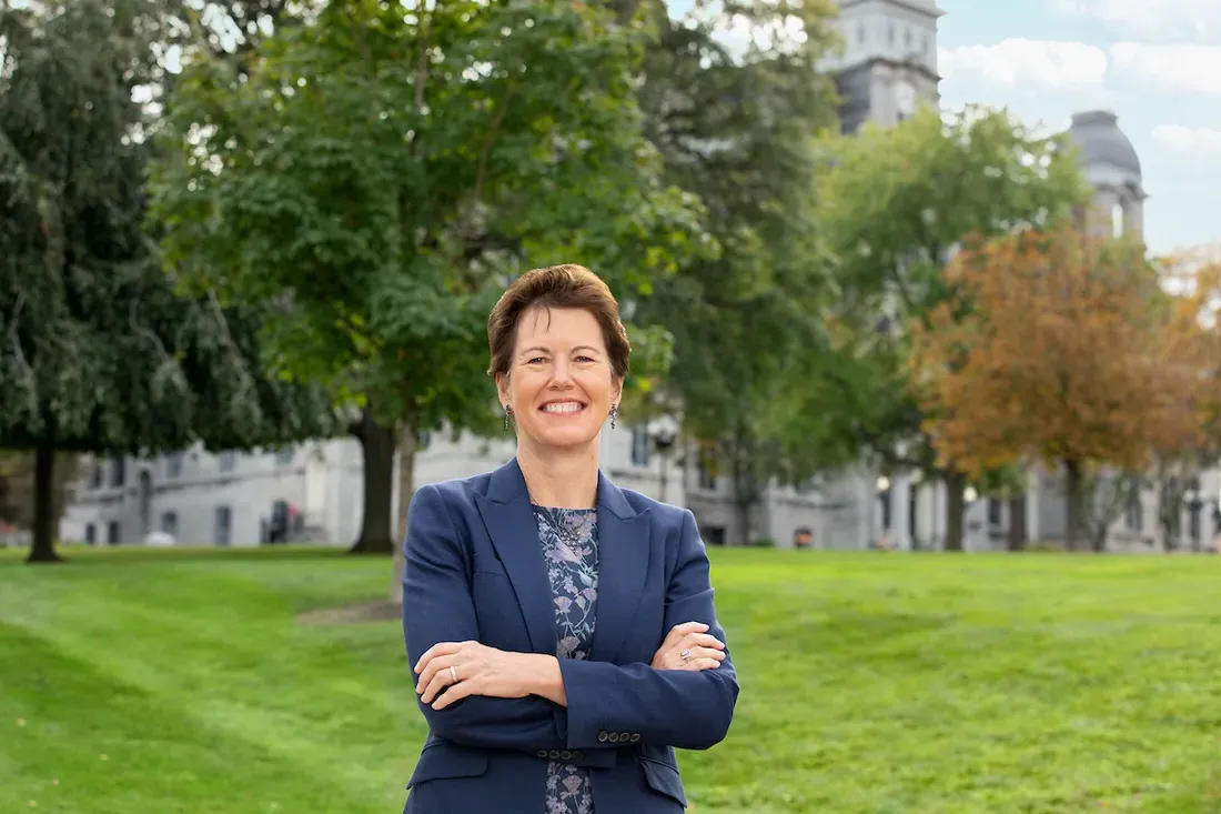 Gretchen Ritter standing and smiling outside.